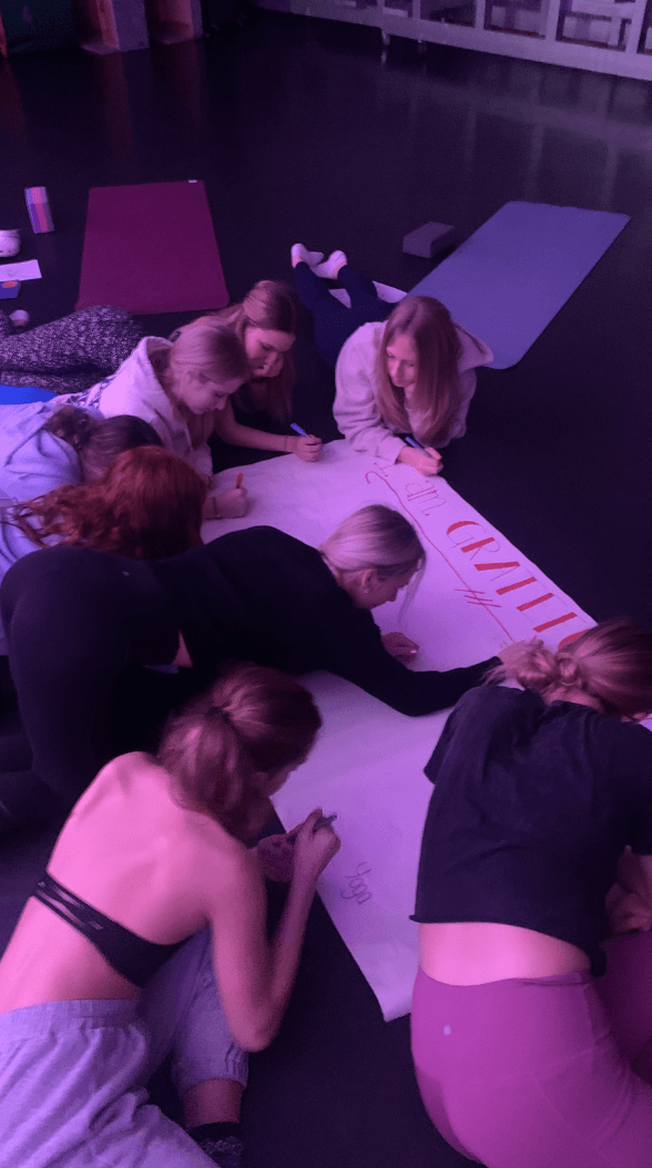 dancers writing on poster board
